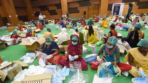 Patna: Volunteers pack masks, sanitisers and other essentials for polling officers at a COVID Protection Kit Packaging Centre, Gyan Bhawan in Patna. (Santosh Kumar/ Hindustan Times) Patna: Volunteers pack masks, sanitisers and other essentials for polling officers at a COVID Protection Kit Packaging Centre, Gyan Bhawan in Patna. (Santosh Kumar/ Hindustan Times)