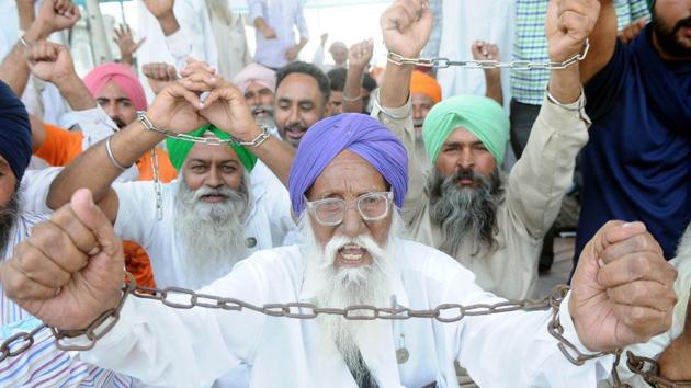 Members of various farmers organizations block toll gates on NH 7 during a protest over the new farm laws, in Patiala on October 15. Stubble burning started at the time farmer bodies were protesting against three farm bills approved in the winter session of Parliament and any action against the stubble burners could have aggravated the situation on the ground, officials in the two states also told HT on condition of anonymity. (Bharat Bhushan / HT Photo)