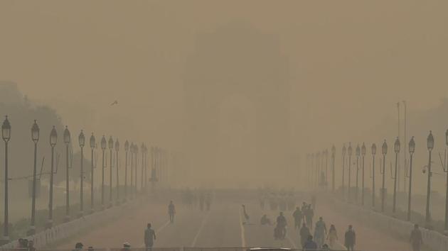 A blanket of haze covers the India Gate with morning walkers also seen in New Delhi on October 15. Farmers burn paddy stubble to clear fields for sowing of winter wheat crop, 90% of which is procured by the government to sustain the Public Distribution System (PDS). The fires send fumes into air causing massive pollution across the entire northern plains. (Manvender Vashisht/ PTI)