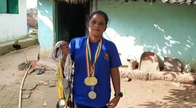 Bimla Munda shows of her medals that she had won in karate.(HT PHOTO)