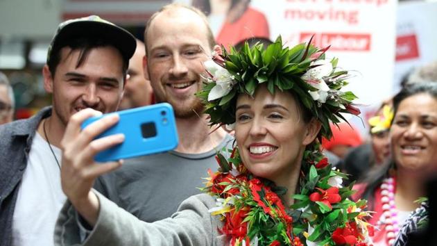 New Zealand's Prime Minister Jacinda Ardern takes pictures with supporters during a campaign outing, in Auckland on October 10.(Reuters File Photo)