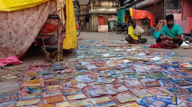Shopkeepers put goods out to dry in an attempt to recover stock spoilt from flood waters in Pandharpur on October 17.  The rainfall has affected over 40,000 people in five districts of the state, HT reported. Solapur has been the worst affected with 32,531 people displaced, followed by Pune district where 6,221 people have been affected so far. (HT Photo) 