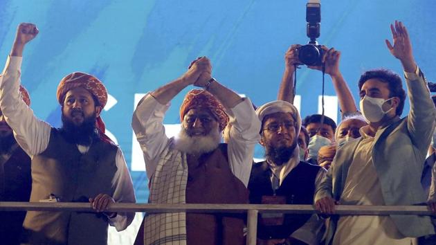 Karachi: Leaders of the Pakistan Democratic Movement, Maulana, Fazal-ur-Rehman, second left, Bilawal Bhutto Zardari, right, wave to their supporters as they arrive to attend in anti government rally, in Karachi, Pakistan, Sunday, Oct. 18, 2020. Protests took place in a campaign against Prime Minister Imran Khan to force him step down over what they say is his failure in handling the nation's ailing economy. AP/PTI(AP18-10-2020_000212B) (AP) Karachi: Leaders of the Pakistan Democratic Movement, Maulana, Fazal-ur-Rehman, second left, Bilawal Bhutto Zardari, right, wave to their supporters as they arrive to attend in anti government rally, in Karachi, Pakistan, Sunday, Oct. 18, 2020. Protests took place in a campaign against Prime Minister Imran Khan to force him step down over what they say is his failure in handling the nation's ailing economy. AP/PTI(AP18-10-2020_000212B) (AP)