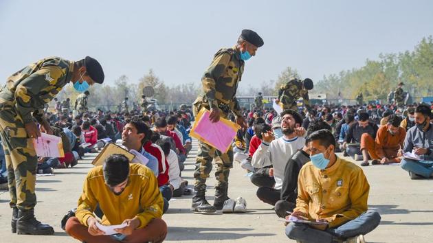 Srinagar: BSF personnel keep vigil on aspirants appearing in an entrance exam, conducted by them during a recruitment rally, at Humhama on the outskirts of Srinagar, Sunday, Oct. 18, 2020. BSF held the second round of recruitment in the form of written test at its nine centers in Jammu & Kashmir and Ladakh.(PTI)