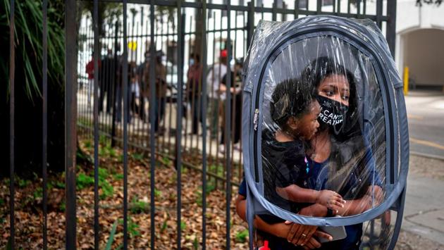 Dana Clark, and her son 18 month old Mason, wait in line at City Hall as early voting begins in New Orleans, Louisiana on October 16. A record-shattering avalanche of early votes is leading election experts to predict that a record 150 million votes may be cast and turnout rates could be higher than in any presidential election since 1908, AP reported.