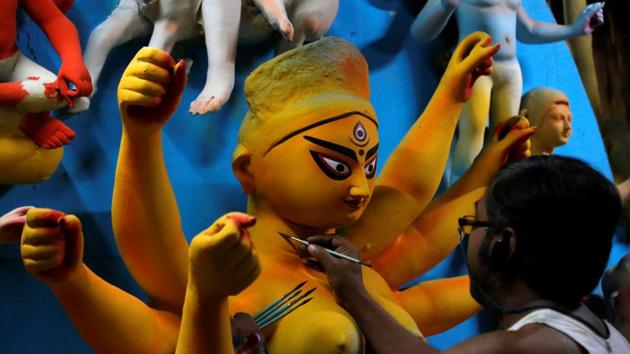 An artisan paints an idol of Hindu goddess Durga at a workshop ahead of the Durga Puja festival, amidst the spread of the coronavirus disease in Kolkata.(REUTERS)