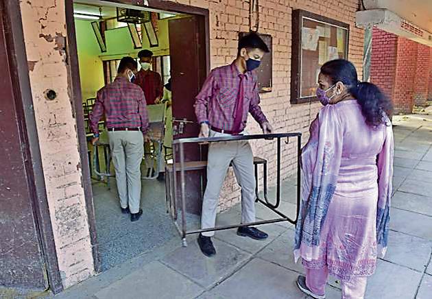 Students of Government Smart School, PAU, moving the benches themselves on Monday.(Gurpreet Singh/HT)