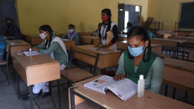 Students wearing face masks attend a class after schools partially reopened in Makanpur, Ghaziabad, India on October 19. As for the US, around 247 cases have been observed per 10,000 people there. For India and Brazil, those numbers stand at 55 cases and 248 cases per 10,000 people respectively, Reuters reported. (Raj K Raj / HT Photo)