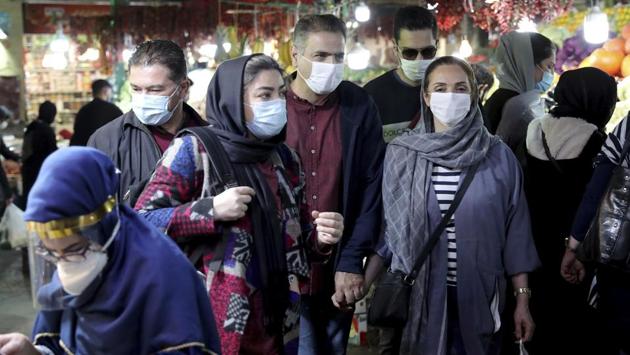 People seen wearing face masks at the Tajrish Traditional Bazaar in Tehran, Iran on October 15. Iran, the hardest-hit country in the Middle East, extended restrictions and closures in its capital Tehran into the third week on October 17, as its death toll rose above 30,000. (Ebrahim Noroozi / AP)