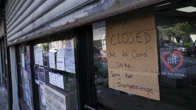 A public notice hangs outside a shuttered store in New York, US on October 15. The United States, India, and Brazil remain the worst affected countries in the world. COVID-19 cases in North, Central, and South America represent about 47.27% of global cases. (John Minchillo / AP)