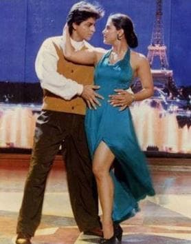 Given how in satin slip numbers are these days, Kajol’s peacock green halter necked gown, with a thigh-high slit would be super fashionable even today. (Movie still)