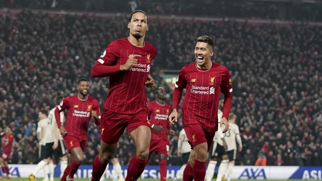 Liverpool's Virgil van Dijk, left, celebrates scoring his side's first goal during the English Premier League soccer match between Liverpool and Manchester United at Anfield Stadium in Liverpool, Sunday, Jan. 19, 2020.(AP Photo/Jon Super) (AP) Liverpool's Virgil van Dijk, left, celebrates scoring his side's first goal during the English Premier League soccer match between Liverpool and Manchester United at Anfield Stadium in Liverpool, Sunday, Jan. 19, 2020.(AP Photo/Jon Super) (AP)