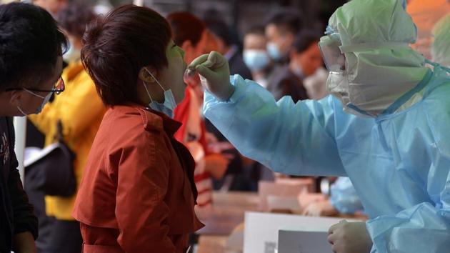 In picture - A medical staff takes a swab from a woman at Qingdao. Representational image.(AP) In picture - A medical staff takes a swab from a woman at Qingdao. Representational image.(AP)