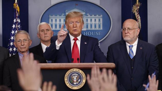 President Donald Trump, center, points as he prepares to answer question after speaking about the coronavirus in the press briefing room at the White House in Washington. (AP Photo/Carolyn Kaster, File)(AP)
