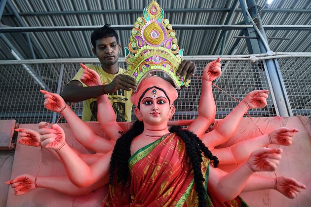 An artisan prepares an idol of Hindu deity Durga in Chennai on October 17. (PTI)
