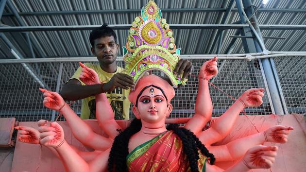 : An artisan gives final touches to an idol of Goddess Durga. (PTI) : An artisan gives final touches to an idol of Goddess Durga. (PTI)