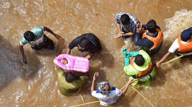 Hyderabad: GHMC personnel carry an infant during an operation to move flood-affected people to a safer place, at Hafiz Baba Nagar in Hyderabad. (PTI) Hyderabad: GHMC personnel carry an infant during an operation to move flood-affected people to a safer place, at Hafiz Baba Nagar in Hyderabad. (PTI)