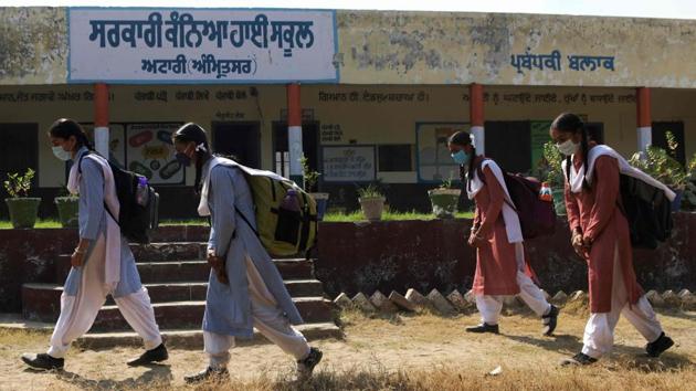Students arrive to attend classes at a government girls school in Attari village near the India-Pakistan Wagah border post on October 19. India, which is the second worst-affected after the United States, has added 1.3 million Covid-19 cases to its tally since October 1 while also implementing further relaxations to restrictions that were imposed as part of the lockdown in March. (Narinder Nanu / AFP)