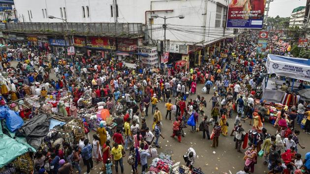A huge crowd of people seen shopping at New Market area ahead of Durga Puja in Kolkata on October 18. In West Bengal, the Calcutta High Court banned visitors from pandals that have already attracted many thousands of devotees who flouted Covid-19 protocols on October 19 – three days before the puja celebrations kicked off. (Ashok Bhaumik / PTI)