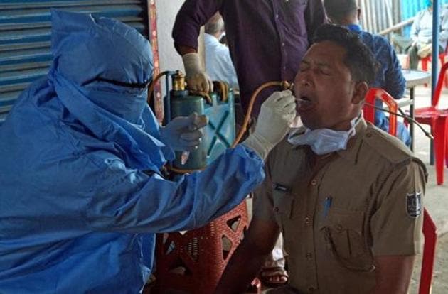 A health worker collects swab samples of a policeman for Covid-19 test in Bhubaneswar.(ANI FILE) A health worker collects swab samples of a policeman for Covid-19 test in Bhubaneswar.(ANI FILE)