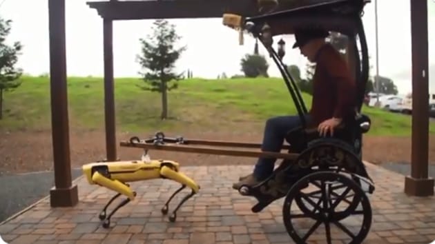 The image shows the robot dog called Spot pulling a rickshaw.(YouTube/@AdamSavage’sTested)
