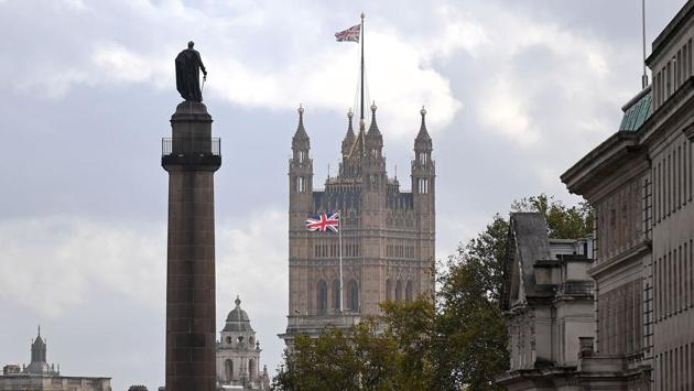 A union flag flies atop the Victoria Tower at Britain’s Houses of Parliament in London on October 20. According to AFP, a royal decree purportedly issued in the 17th century, stated there must be six ravens on site at all times. However, the Ravenmaster keeps eight just in case. Merlina, Poppy, Erin, Jubilee, Rocky, Harris, Gripp and George currently occupy the Tower of London. (Justin Tallis / AFP)