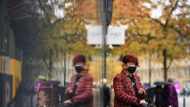A woman is reflected on a window as she leaves a shop in central Sheffield, Yorkshire, prior to further lockdown measures as the number of Covid-19 cases rises.(AFP) A woman is reflected on a window as she leaves a shop in central Sheffield, Yorkshire, prior to further lockdown measures as the number of Covid-19 cases rises.(AFP)