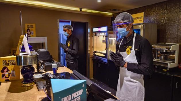 A worker at PVR cineplex is wearing face shield and mask as part of Covid-19 guidelines issued by the government. (PTI File Photo) A worker at PVR cineplex is wearing face shield and mask as part of Covid-19 guidelines issued by the government. (PTI File Photo)