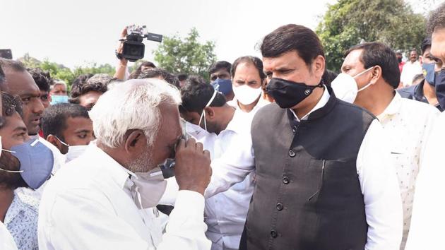 Former Maharashtra chief minister Devendra Fadnavis interacts with farmers during a visit to Apsinga village to inspect crops damaged due to unseasonal rains, in Tuljapur taluka of Osmanabad, on October 20. (PTI) Former Maharashtra chief minister Devendra Fadnavis interacts with farmers during a visit to Apsinga village to inspect crops damaged due to unseasonal rains, in Tuljapur taluka of Osmanabad, on October 20. (PTI)