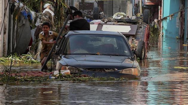 A boy wades through a flooded street after heavy rainfall at Baba Nagar in Hyderabad, on October 18. (AP) A boy wades through a flooded street after heavy rainfall at Baba Nagar in Hyderabad, on October 18. (AP)