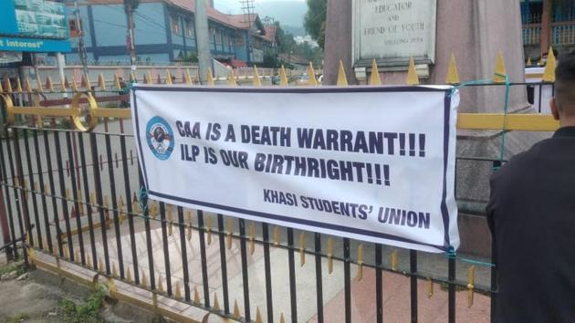 Posters being put up by activists of the Khasi Students’ Union in Shillong on Wednesday.(HT Photo)