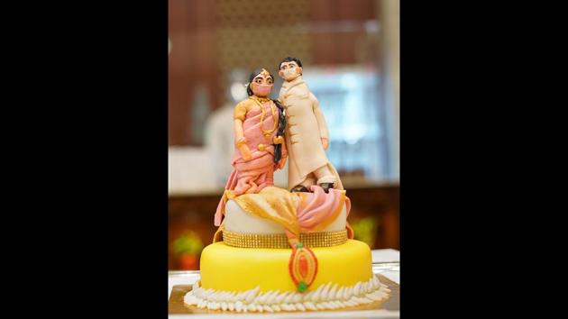 Couples are doing what they can to take the pandemic in their stride — cake-top dolls in masks, zoom lenses so photographers don’t have to go too close to the seniors zone. (Photo courtesy Megha Israni)