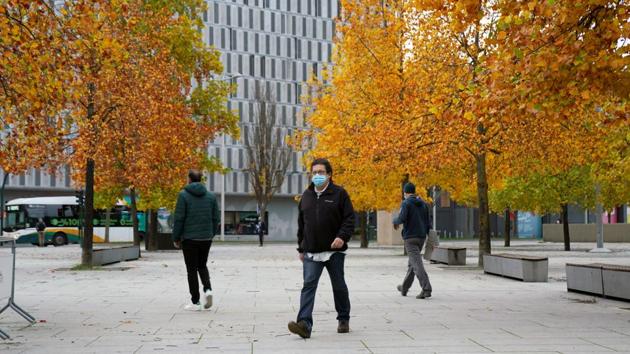 People in face masks walk through Pamplona after the Navarran local government limited all non-essential movement in and out of the region for two weeks, on October 21. The country of 47 million is among those hardest hit by the Covid-19 pandemic, with more than 34,000 deaths attributed to the disease. (Vincent West / REUTERS)
