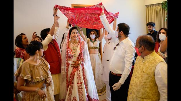 Where possible, couples are opting for safe and familiar spaces like the home, roping in neighbours to allow for more room for their small group of guests to spread out — as was done at this home-hosted wedding in Mumbai. (Photo courtesy WeddingNama)
