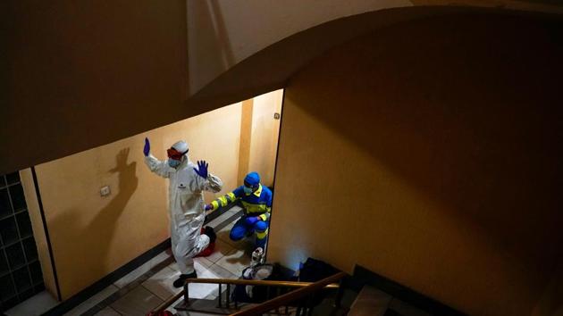 Emergency services doctor Carlos Rubio is assisted by technician Jose Sevillano in his protective gear after examining a patient in Madrid on October 19. After slowing to a trickle in the wake of Spain’s strict March-to-June lockdown, the infection rate accelerated to frequently exceed 10,000 cases a day from late August, hitting a new peak of more than 16,000 last week. (Juan Medina / REUTERS)