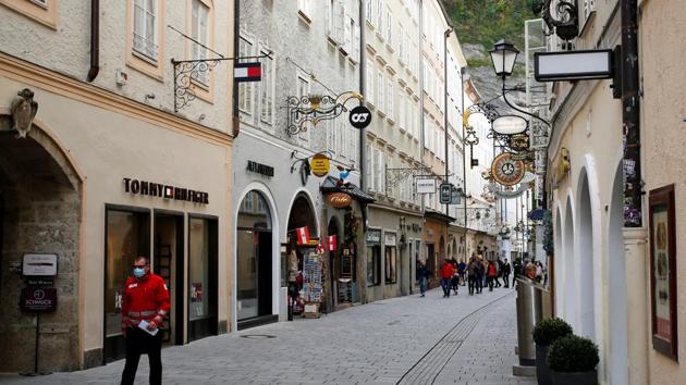 Man, wearing a protective mask, walks down Getreidegasse, as the coronavirus disease (Covid-19) outbreak continues, in Salzburg, Austria October 21, 2020. (Reuters) Man, wearing a protective mask, walks down Getreidegasse, as the coronavirus disease (Covid-19) outbreak continues, in Salzburg, Austria October 21, 2020. (Reuters)