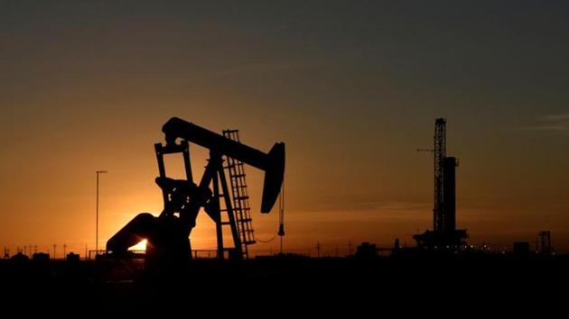 A pump jack operates in front of a drilling rig at sunset in an oil field in Midland, Texas US.(Reuters File Photo)