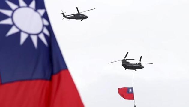 Helicopters fly over President Office with Taiwan National flag during the National Day celebrations in Taipei, Taiwan on October 10, 2020.(AP File Photo)