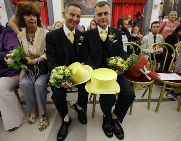 FILE - In this May 21, 2015 file photo, Angelo Albanesi, left, and Pier Giorgio De Simone wait for their civil union to be registered by a municipality officer during a ceremony in Rome's Campidoglio Capitol Hill. Francis’ outreach to gays dates to his first foreign trip in 2013, when he uttered the now-famous words “Who am I to judge,” when asked during an airborne news conference returning home from Rio de Janiero about a purportedly gay priest. (AP)