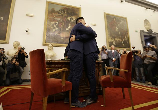 FILE - In this May 21, 2015 file photo Leonardo Pace, left, hugs Fabio Motti as their civil union is being registered by a municipality officer during a ceremony in Rome's Campidoglio Capitol Hill. While serving as archbishop of Buenos Aires, Francis endorsed civil unions for gay couples as an alternative to same-sex marriages. However, he had never come out publicly in favor of civil unions as pope. (AP)