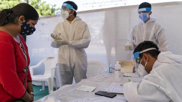 In Picture - Health workers dressed in personal protective equipment at a rapid-antigen methodology Covid-19 test site in Ahmedabad.(Bloomberg) In Picture - Health workers dressed in personal protective equipment at a rapid-antigen methodology Covid-19 test site in Ahmedabad.(Bloomberg)