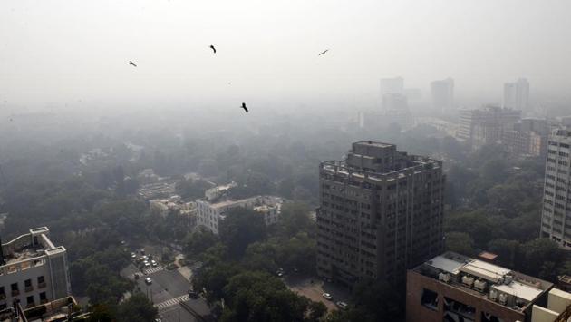 An aerial view of Connaught Place blanketed in heavy haze on October 22. According to the Graded Response Action Plan (GRAP), first implemented in 2017 through the Supreme Court-appointed EPCA, if the air quality continues to be “very poor” for 48 hours, strict measures such as enhancing parking fees three to four times need to be brought in. (Vipin Kumar / HT Photo)