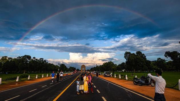 People make a photograph against a rainbow near India Gate at Rajpath in New Delhi on August 21. With pre-emptive measures listed under the winter segment of the Supreme Court-approved Graded Response Action Plan (GRAP) already in place, the Capital will now have to turn to strict restrictions and stringent enforcement to survive the return of an annual air emergency. (Amal KS / HT Photo)