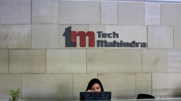 An employee sits at the front desk inside Tech Mahindra’s office in Noida in this file photo.(Reuters Photo)