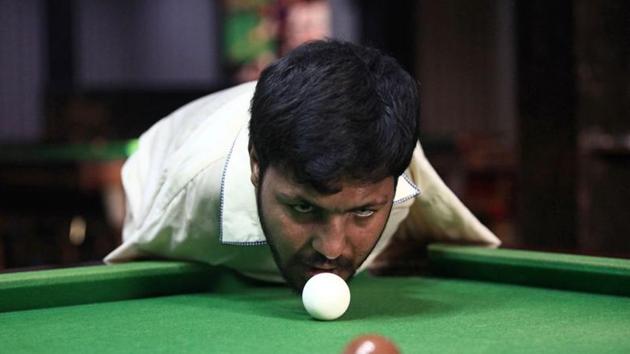 Muhammad Ikram, 32, who was born without arms, plays snooker with his chin at a local club.(REUTERS)