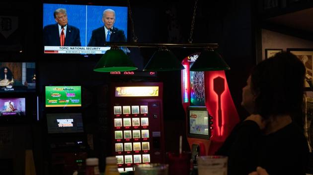 People watch the US presidential debate between President Donald Trump and Democratic candidate Joe Biden at a bar in Clawson, Michigan, US. (Bloomberg) People watch the US presidential debate between President Donald Trump and Democratic candidate Joe Biden at a bar in Clawson, Michigan, US. (Bloomberg)