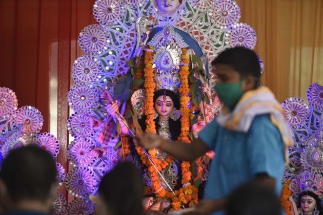 Gurugram, India-October 24: A priest offers prayers to Hindu deity Durga during the Durga Puja festival organised by Axomiya Welfare society at Community Centre in Sector 46, in Gurugram, India, on Saturday, 24 October 2020. (Parveen Kumar/Hindustan Times)