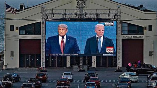 People watch the final presidential debate between Donald Trump and Joe Biden on a giant screen from their vehicles at Fort Mason Center in San Francisco, US. People watch the final presidential debate between Donald Trump and Joe Biden on a giant screen from their vehicles at Fort Mason Center in San Francisco, US.