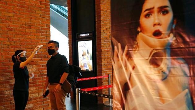 Man is checked with a thermal scanner before entering the CGV cinema amid the coronavirus pandemic in Jakarta, Indonesia on October 21. In Southeast Asia, Indonesia surpassed the Philippines last week as the worst-hit nation with more than 380,000 infections. (Ajeng Dinar Ulfiana / REUTERS)