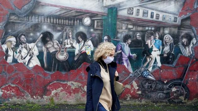 A woman walks past a wall mural during the resurging coronavirus outbreak in Galway, Ireland. (REUTERS) A woman walks past a wall mural during the resurging coronavirus outbreak in Galway, Ireland. (REUTERS)